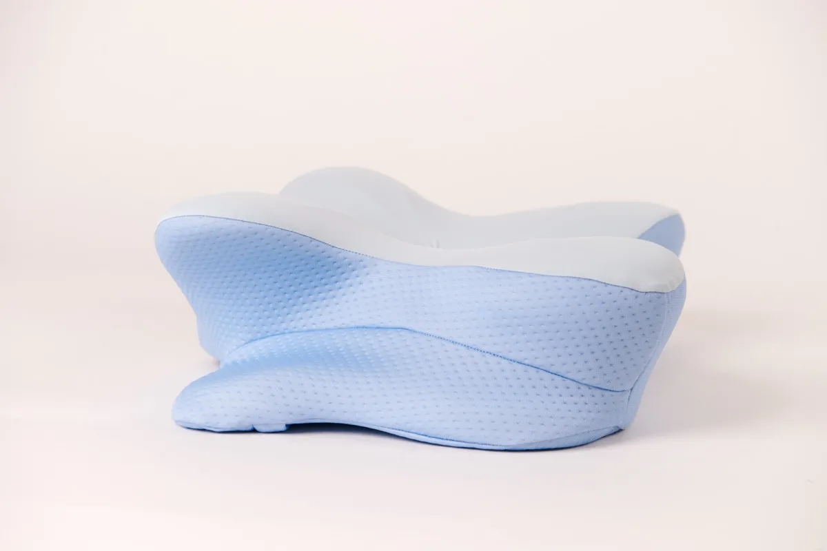 Ergonomic contoured memory foam pillow showing the butterfly-shaped cervical support design