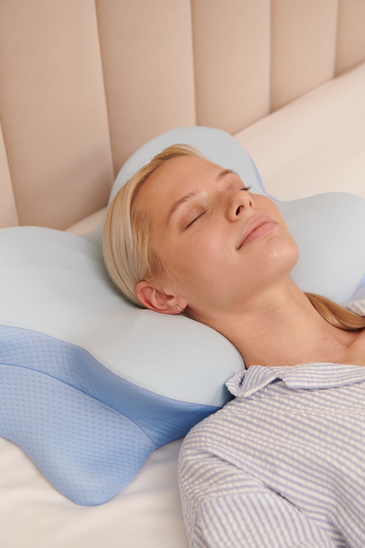 Woman sleeping comfortably on ergonomic contour pillow with proper neck support