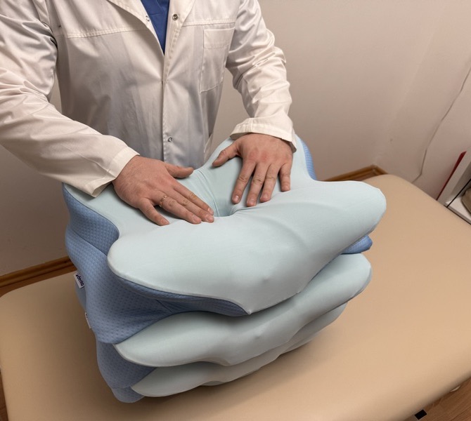 Hands pressing into the memory foam to show slow-rebound density
