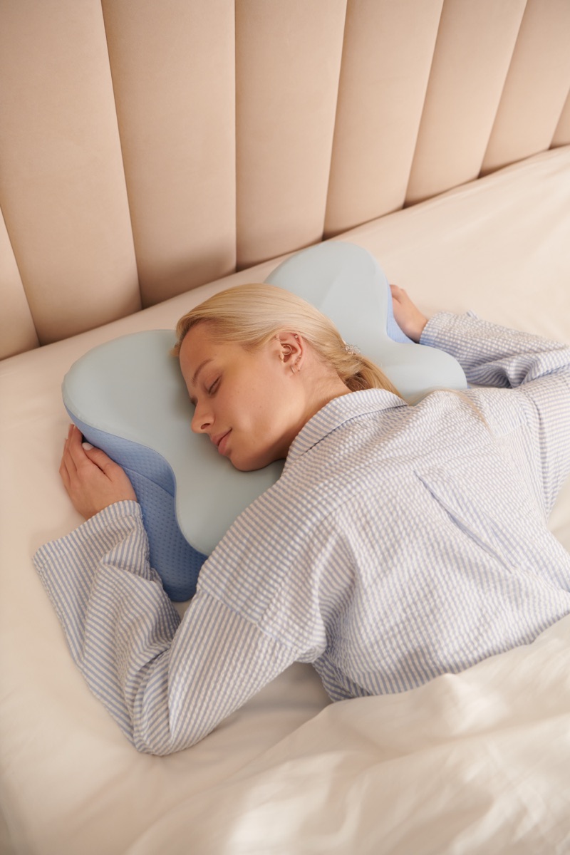 Side sleeper using the butterfly pillow with arm tucked into the cutout